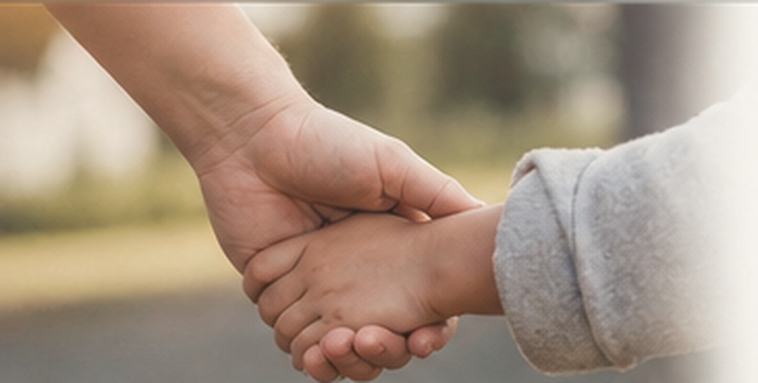 A child holding an adult's hand